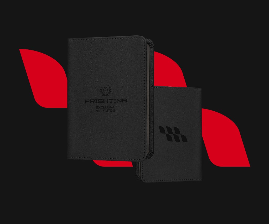 Showroom interior signage — chrome 3D logo on dark panelled wall